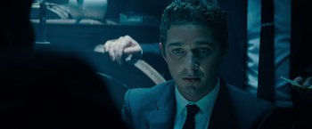 Movie still from “Transformers: Dark of the Moon” (2011), directed by Michael Bay – A person wearing a suit and tie; Close Up shot, Over the shoulder angle