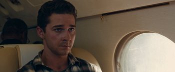 Movie still from “Transformers: Dark of the Moon” (2011), directed by Michael Bay – A person sitting on a plane; Close Up shot, Over the shoulder angle