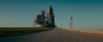 A road leading to a space shuttle on a runway
