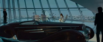 Movie still from “Transformers: Dark of the Moon” (2011), directed by Michael Bay – A woman sitting on a chair in front of a window; Wide shot, High angle