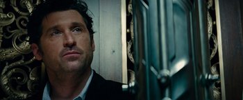 Movie still from “Transformers: Dark of the Moon” (2011), directed by Michael Bay – A person wearing a suit and tie; Close Up shot, Over the shoulder angle