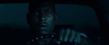 Movie still from “Transformers: Dark of the Moon” (2011), directed by Michael Bay – A person holding a steering wheel; Close Up shot, Low angle