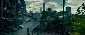 Movie still from “Transformers: Dark of the Moon” (2011), directed by Michael Bay – People are walking down a street near a city; Extreme Wide shot, High angle