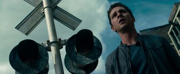 Movie still from “Transformers: Dark of the Moon” (2011), directed by Michael Bay – A man standing next to a traffic light; Close Up shot, Low angle