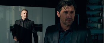 Movie still from “Transformers: Dark of the Moon” (2011), directed by Michael Bay – A person wearing a suit and tie; Close Up shot, Over the shoulder angle