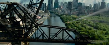 Movie still from “Transformers: Dark of the Moon” (2011), directed by Michael Bay – A view of a city from a bridge over a river; Extreme Wide shot, High angle