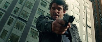 Movie still from “Transformers: Dark of the Moon” (2011), directed by Michael Bay – A man is holding a gun in his hand; Close Up shot, Low angle