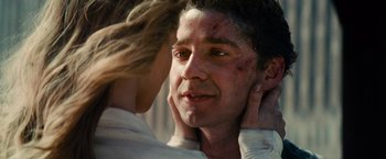 Movie still from “Transformers: Dark of the Moon” (2011), directed by Michael Bay – A person touching a man's face; Close Up shot, Low angle