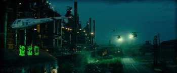 Movie still from “Transformers: Revenge of the Fallen” (2009), directed by Michael Bay – An industrial area at night with smoke coming out of the chimney; Extreme Wide shot, High angle
