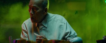 Movie still from “Transformers: Revenge of the Fallen” (2009), directed by Michael Bay – An older man sitting at a table holding chopsticks; Close Up shot, Over the shoulder angle