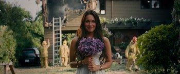 Movie still from “Transformers: Revenge of the Fallen” (2009), directed by Michael Bay – A beautiful woman holding a bouquet of purple flowers; Medium shot, Over the shoulder angle