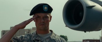 Movie still from “Transformers: Revenge of the Fallen” (2009), directed by Michael Bay – A soldier saluting while wearing a beret; Close Up shot, Low angle