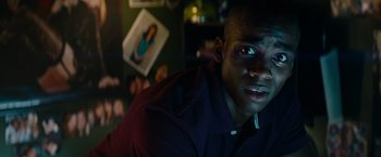 Movie still from “Transformers: Revenge of the Fallen” (2009), directed by Michael Bay – A person wearing a purple shirt; Close Up shot, Over the shoulder angle