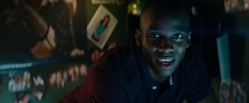 Movie still from “Transformers: Revenge of the Fallen” (2009), directed by Michael Bay – A person sitting in front of a wall; Close Up shot, Low angle