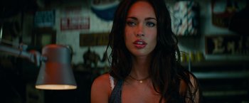 Movie still from “Transformers: Revenge of the Fallen” (2009), directed by Michael Bay – A beautiful woman with long dark brown hair and blue eyes; Close Up shot, Over the shoulder angle