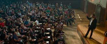 Movie still from “Transformers: Revenge of the Fallen” (2009), directed by Michael Bay – A large group of people sitting in a lecture hall; Wide shot, High angle