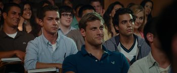 Movie still from “Transformers: Revenge of the Fallen” (2009), directed by Michael Bay – A group of people sitting in front of each other in a room; Close Up shot, Over the shoulder angle