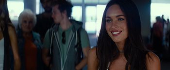 Movie still from “Transformers: Revenge of the Fallen” (2009), directed by Michael Bay – A beautiful young lady smiling for the camera; Close Up shot, Over the shoulder angle