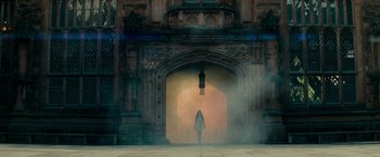 Movie still from “Transformers: Revenge of the Fallen” (2009), directed by Michael Bay – A woman is walking through a doorway with smoke coming out of it; Extreme Wide shot, Low angle