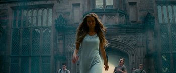 Movie still from “Transformers: Revenge of the Fallen” (2009), directed by Michael Bay – A beautiful young lady walking down a street; Medium shot, Low angle