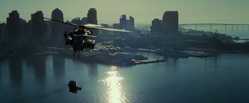 Movie still from “Transformers: Revenge of the Fallen” (2009), directed by Michael Bay – A helicopter flying over a body of water near a city; Extreme Wide shot, High angle