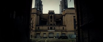 Movie still from “Transformers: Revenge of the Fallen” (2009), directed by Michael Bay – An old building with a large window in the middle of it; Extreme Wide shot, Low angle