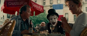 Movie still from “Transformers: Revenge of the Fallen” (2009), directed by Michael Bay – Two people sitting at a table with a wine glass; Medium shot, Over the shoulder angle