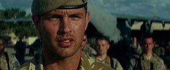 Movie still from “Transformers: Revenge of the Fallen” (2009), directed by Michael Bay – A person wearing a uniform; Close Up shot, Low angle