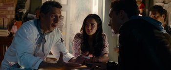 Movie still from “Transformers: Revenge of the Fallen” (2009), directed by Michael Bay – A group of people sitting at a table talking to each other; Close Up shot, Over the shoulder angle