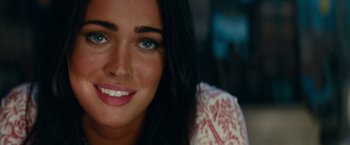 Movie still from “Transformers: Revenge of the Fallen” (2009), directed by Michael Bay – A woman smiling for the camera; Close Up shot, Over the shoulder angle