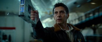 Movie still from “Transformers: Revenge of the Fallen” (2009), directed by Michael Bay – A person holding a gun; Close Up shot, Low angle