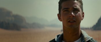 Movie still from “Transformers: Revenge of the Fallen” (2009), directed by Michael Bay – A man's face in a field; Close Up shot, Over the shoulder angle