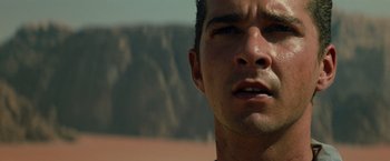 Movie still from “Transformers: Revenge of the Fallen” (2009), directed by Michael Bay – A man's face with a mountain in the background; Close Up shot, Low angle