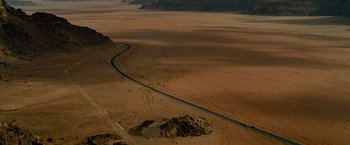 Movie still from “Transformers: Revenge of the Fallen” (2009), directed by Michael Bay – An aerial view of a road in the middle of the desert; Extreme Wide shot, High angle