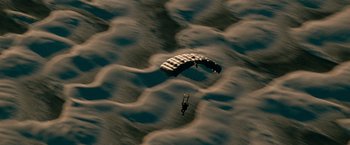 Movie still from “Transformers: Revenge of the Fallen” (2009), directed by Michael Bay – A parachutist is in the air over the water; Extreme Wide shot, Overhead angle