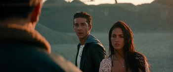 Movie still from “Transformers: Revenge of the Fallen” (2009), directed by Michael Bay – A man and a woman standing next to each other; Close Up shot, Over the shoulder angle