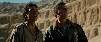Movie still from “Transformers: Revenge of the Fallen” (2009), directed by Michael Bay – Two men standing next to each other in front of a cliff; Close Up shot, Low angle
