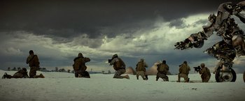Movie still from “Transformers: Revenge of the Fallen” (2009), directed by Michael Bay – A group of soldiers kneeling in the snow near pyramids; Extreme Wide shot, Low angle