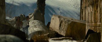 Movie still from “Transformers: Revenge of the Fallen” (2009), directed by Michael Bay – A large rock sitting on top of a sandy beach; Wide shot, Low angle