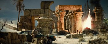 Movie still from “Transformers: Revenge of the Fallen” (2009), directed by Michael Bay – Two men are standing next to an old car in the desert; Extreme Wide shot, Low angle