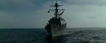 Movie still from “Transformers: Revenge of the Fallen” (2009), directed by Michael Bay – A large boat with flags on it in the ocean; Extreme Wide shot, Low angle
