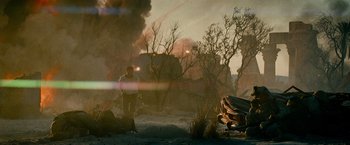 Movie still from “Transformers: Revenge of the Fallen” (2009), directed by Michael Bay – A man standing in the middle of a field near trees; Wide shot, Low angle