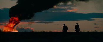 Movie still from “Transformers: Revenge of the Fallen” (2009), directed by Michael Bay – A man standing in the middle of a grassy field; Extreme Wide shot, Low angle