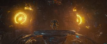 Movie still from “Transformers: Rise of the Beasts” (2023), directed by Steven Caple Jr. – A man standing on top of a platform in the middle of a building; Extreme Wide shot, Low angle