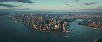 Movie still from “Transformers: Rise of the Beasts” (2023), directed by Steven Caple Jr. – An aerial view of a large city at sunset; Extreme Wide shot, High angle