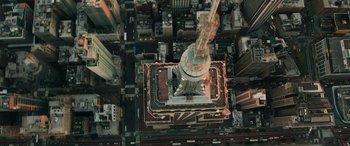 Movie still from “Transformers: Rise of the Beasts” (2023), directed by Steven Caple Jr. – An aerial view of a building with a crane on top; Extreme Wide shot, Overhead angle