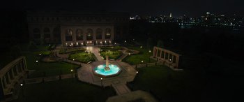 Movie still from “Transformers: Rise of the Beasts” (2023), directed by Steven Caple Jr. – An aerial view of a fountain in a park at night; Extreme Wide shot, High angle