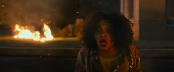 Movie still from “Transformers: Rise of the Beasts” (2023), directed by Steven Caple Jr. – A woman with red paint on her face; Close Up shot, Over the shoulder angle