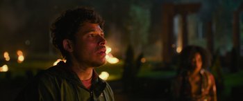 Movie still from “Transformers: Rise of the Beasts” (2023), directed by Steven Caple Jr. – A young man is looking up at the sky at night; Close Up shot, Over the shoulder angle