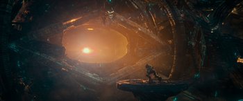 Movie still from “Transformers: Rise of the Beasts” (2023), directed by Steven Caple Jr. – An image of a man that is standing on a rock; Extreme Wide shot, Low angle